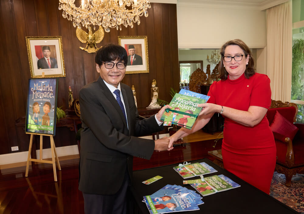 Indonesian Ambassador to Australia accepts a book from the author Dr Susan Neuhaus